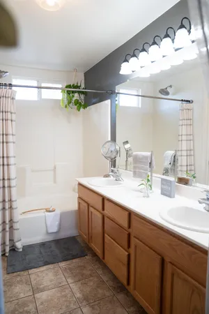a bathroom with a double vanity sink and a mirror