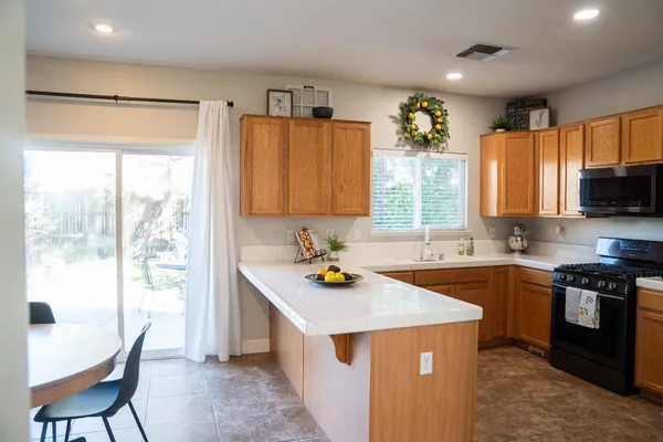 a kitchen with a stove a sink and a refrigerator