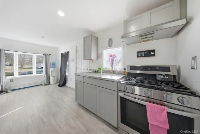 a kitchen with stainless steel appliances granite countertop a stove and a sink