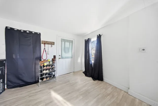 an empty room with window and closet
