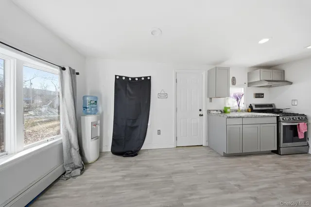 a kitchen with refrigerator and window