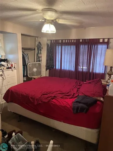 a bed sitting in a bedroom next to a window