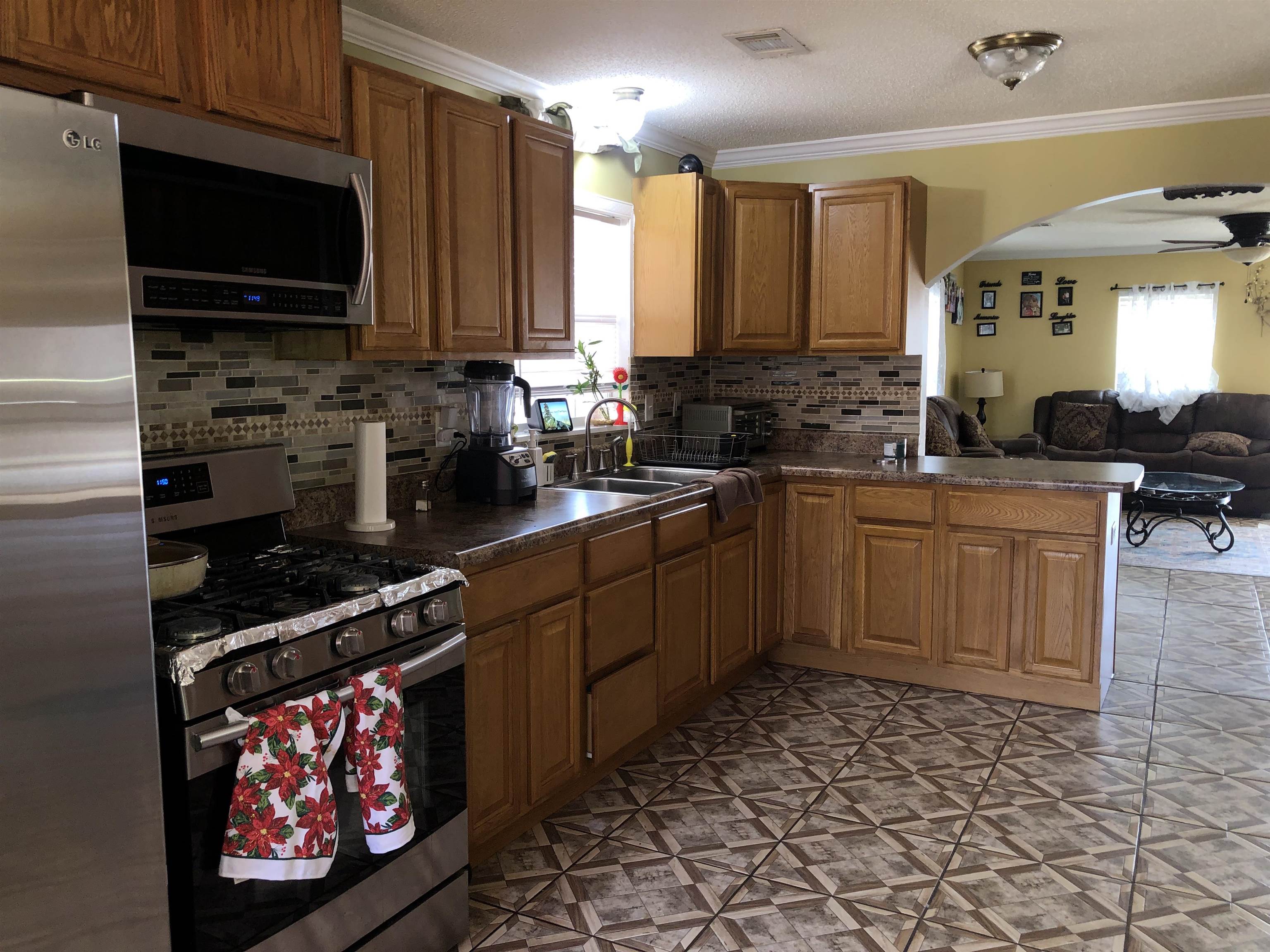 1441 Duke Road Memphis, TN 38122 - Photo 7 of 19 a kitchen with stainless steel appliances a stove sink microwave and cabinets