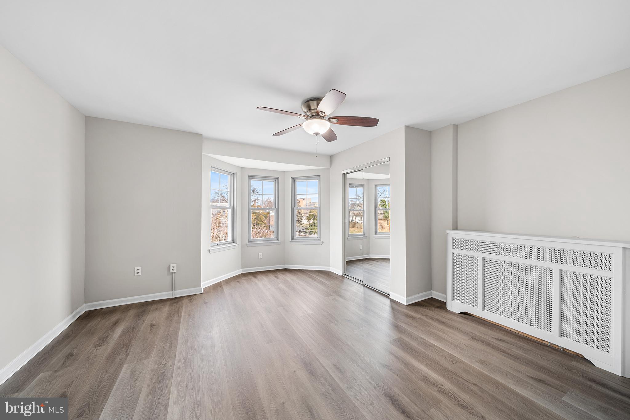 1006 Highland Avenue Chester, PA 19013 - Photo 22 of 29 a view of an empty room with a window and wooden floor