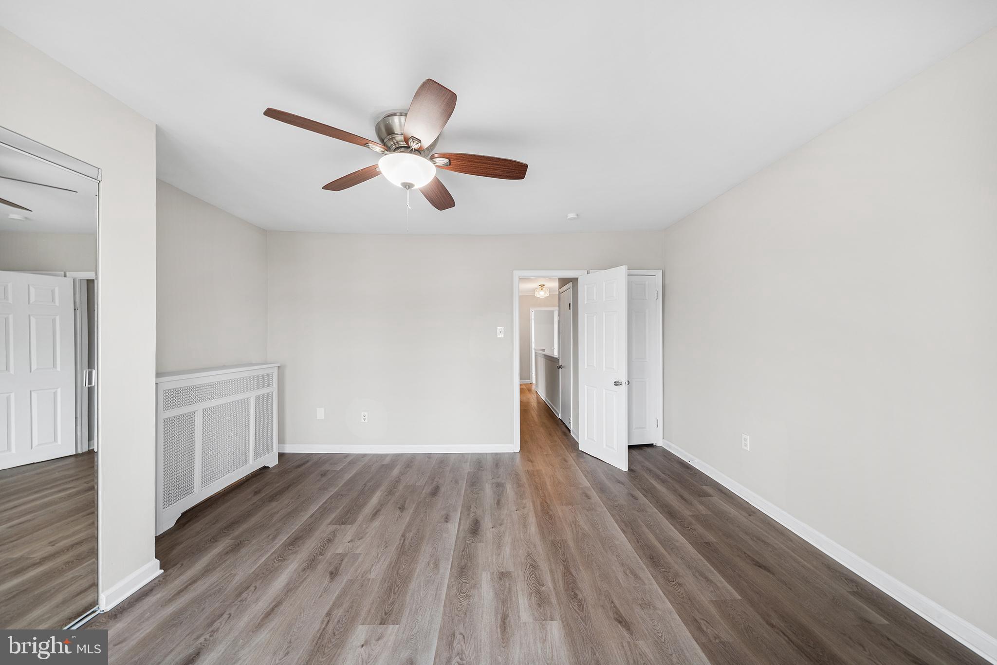 1006 Highland Avenue Chester, PA 19013 - Photo 23 of 29 a view of a room with wooden floor a ceiling fan and window