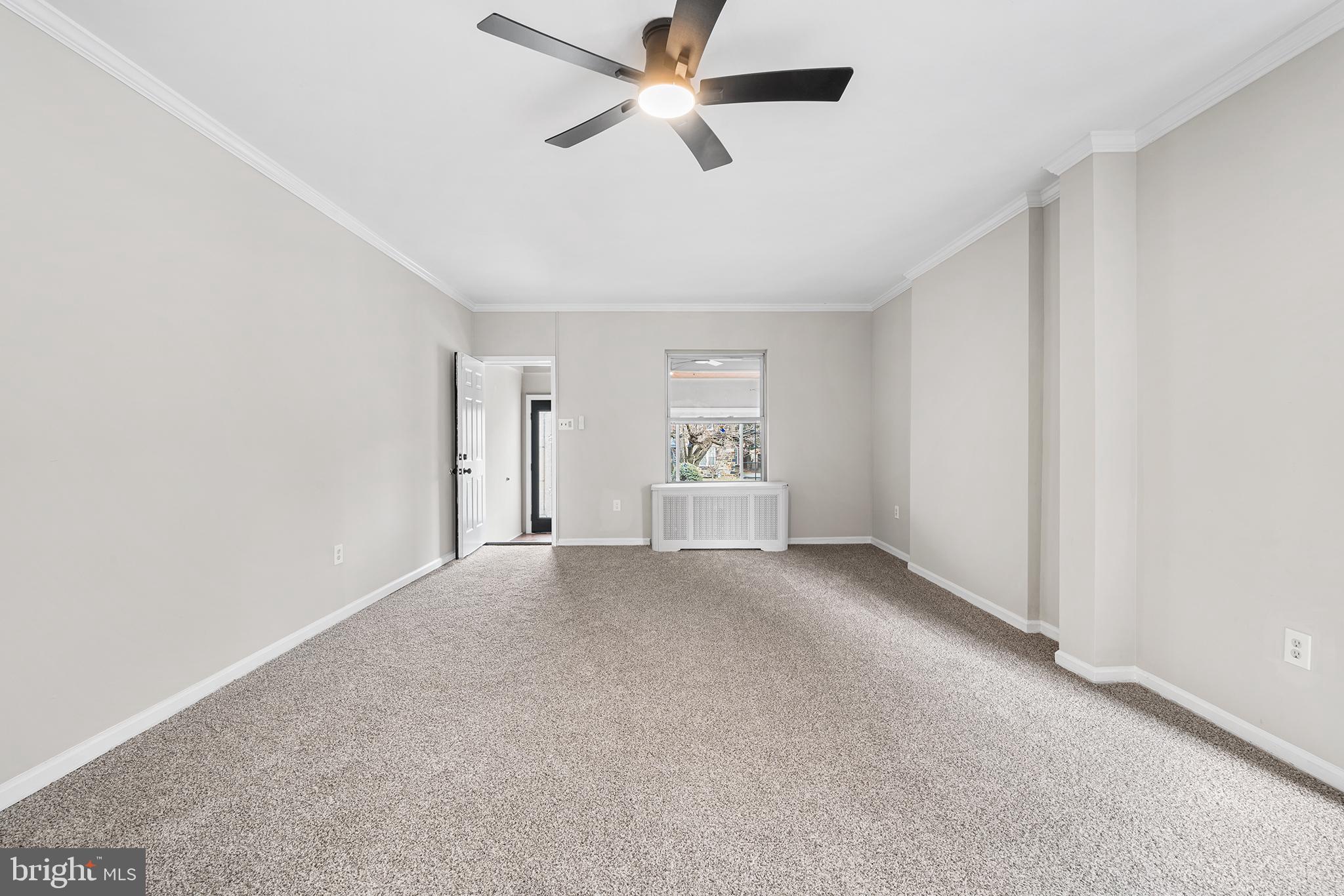1006 Highland Avenue Chester, PA 19013 - Photo 10 of 29 an empty room with chandelier fan and windows