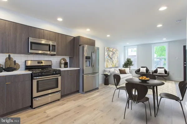 a kitchen with a dining table and chairs