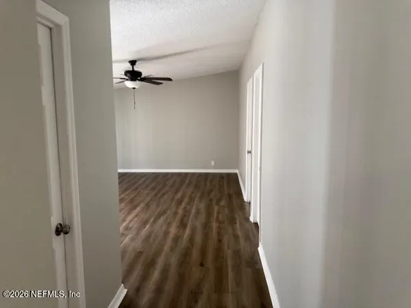 a view of a room with wooden floor and a carpet