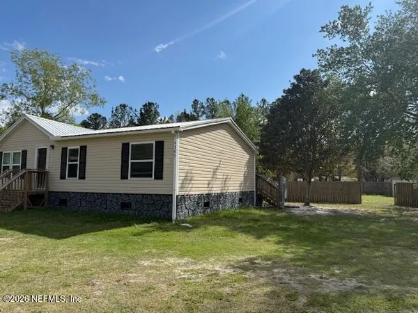 a backyard of a house with table and chairs