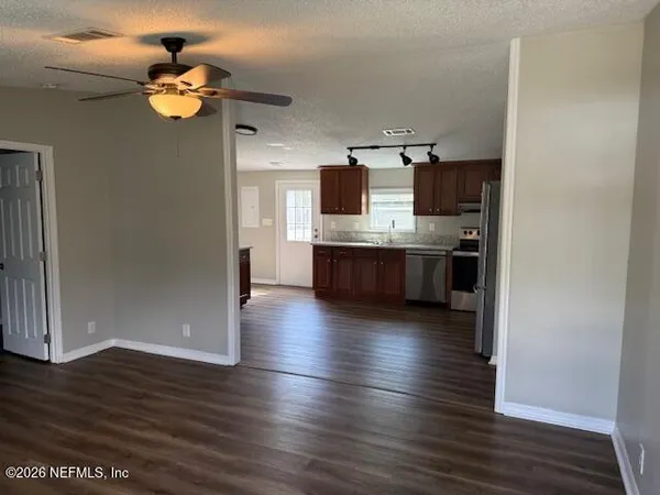 a view of kitchen with sink and wooden floor
