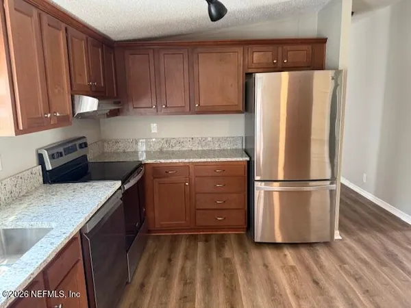 a kitchen with a refrigerator and a sink