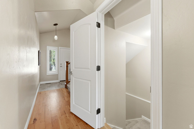 7235 Viansa Court Midvale, UT 84047 - Photo 17 of 43 Corridor featuring lofted ceiling and light wood-type flooring