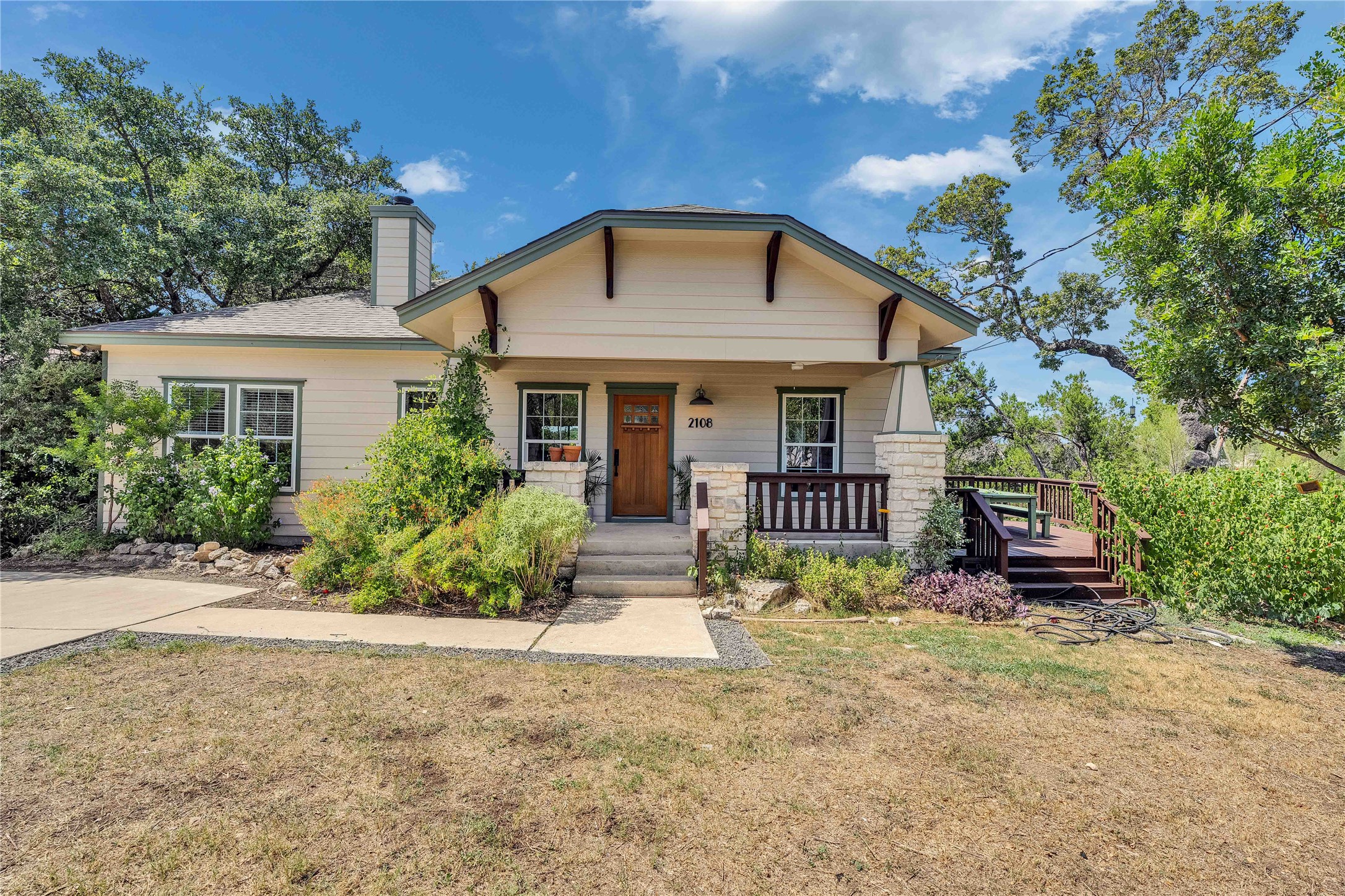 View of front of house featuring a porch, a front lawn, and a chimney