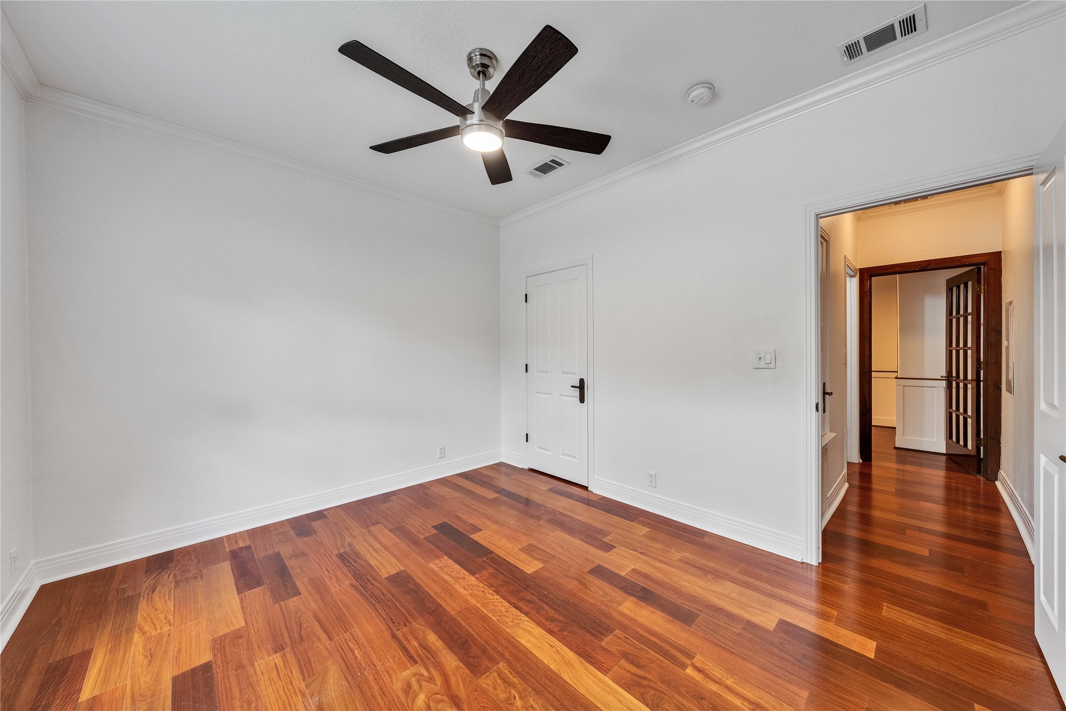 2108 Indian Creek Road Austin, TX 78734 - Photo 19 of 40 Unfurnished bedroom featuring ornamental molding, wood finished floors, and ceiling fan