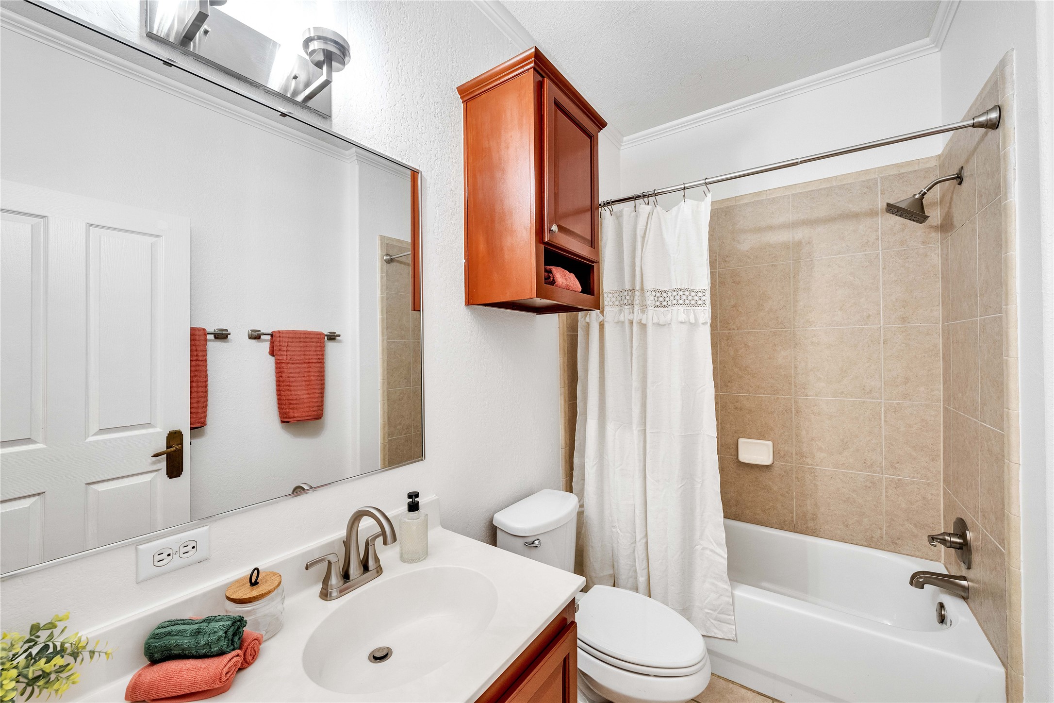 2108 Indian Creek Road Austin, TX 78734 - Photo 21 of 40 Bathroom featuring shower / bath combo, vanity, and crown molding