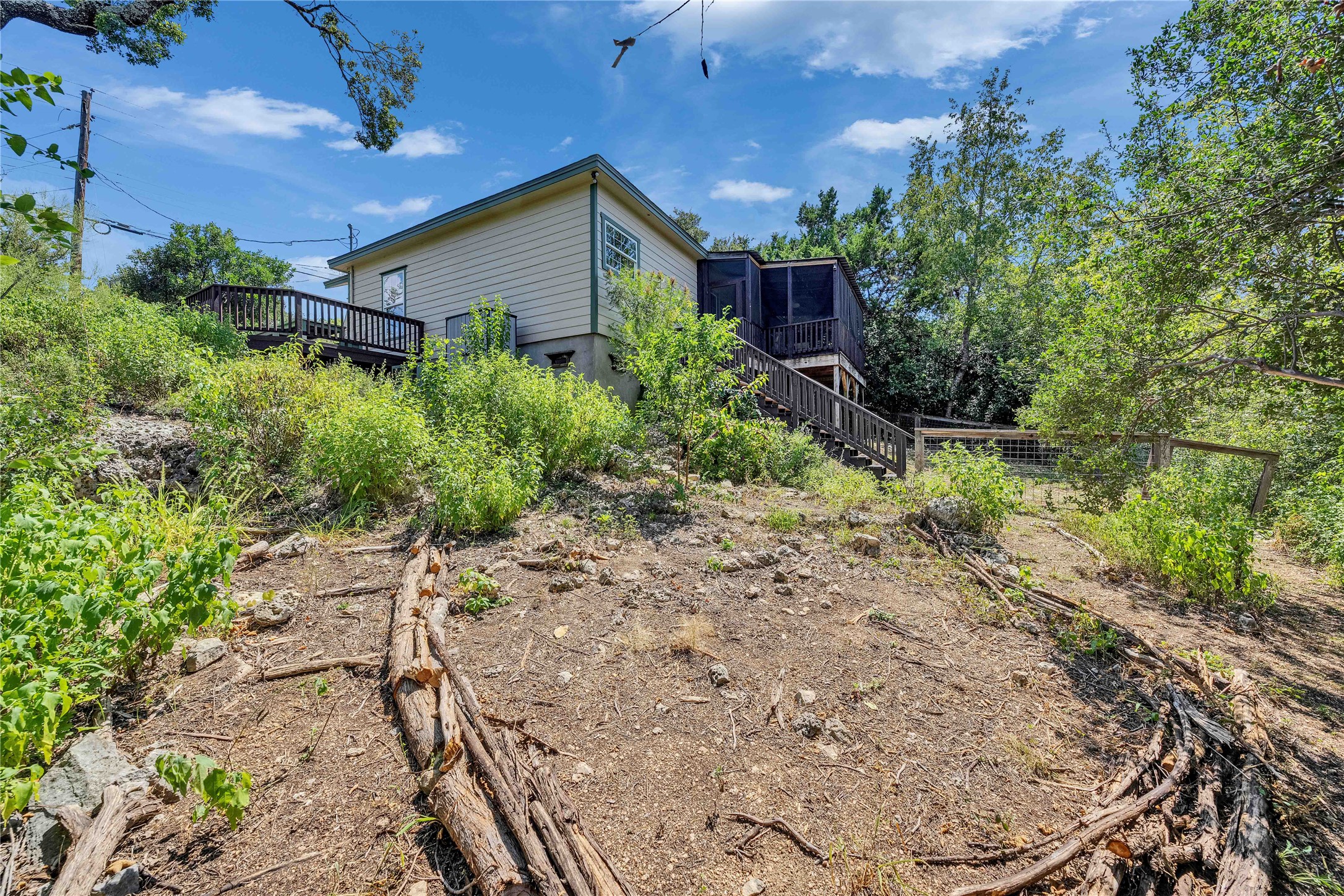 2108 Indian Creek Road Austin, TX 78734 - Photo 25 of 40 Back of property featuring stairs, a sunroom, and a deck