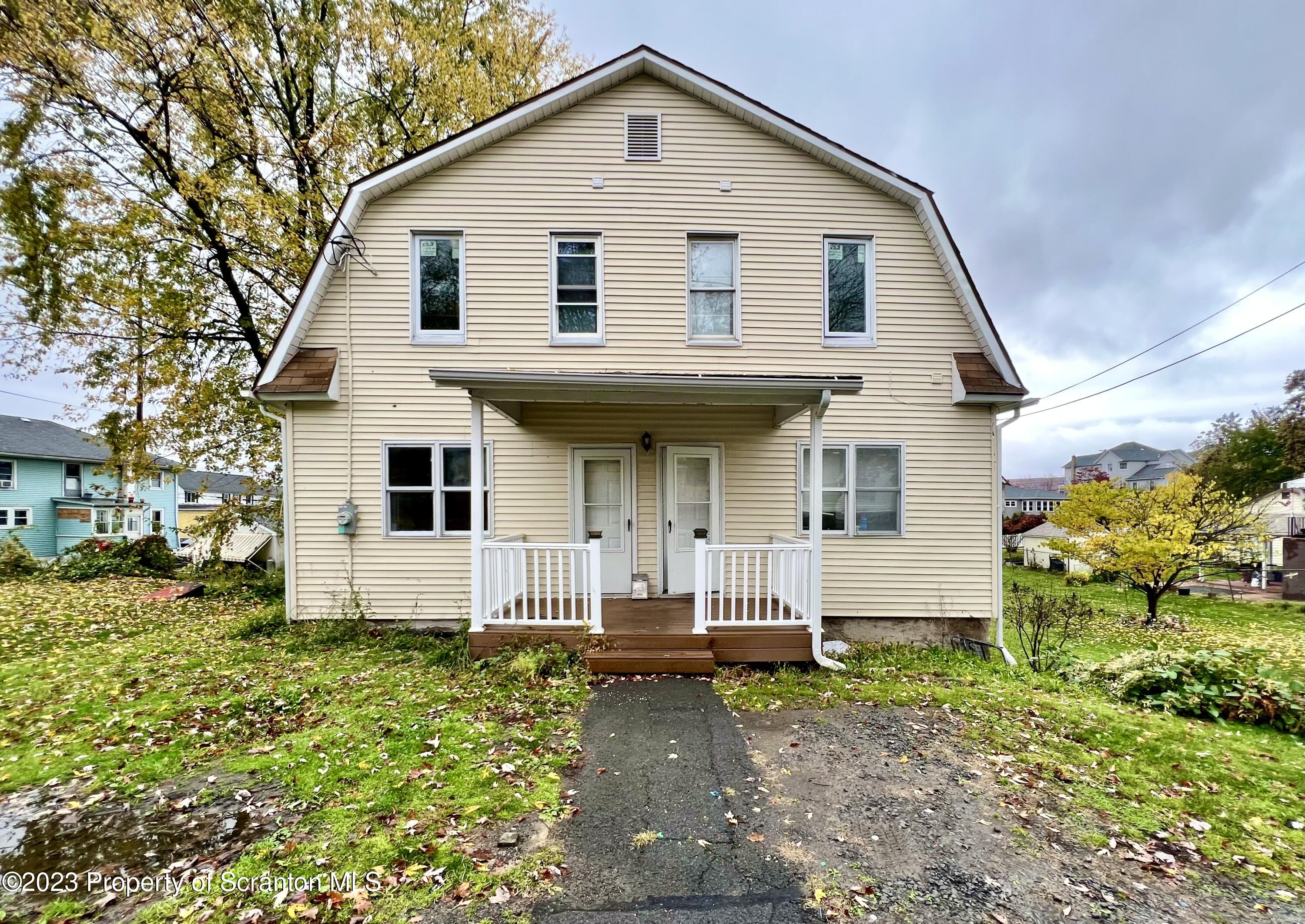 1109 Grove Street Avoca, PA 18641 - Photo 1 of 17 a front view of a house with garden