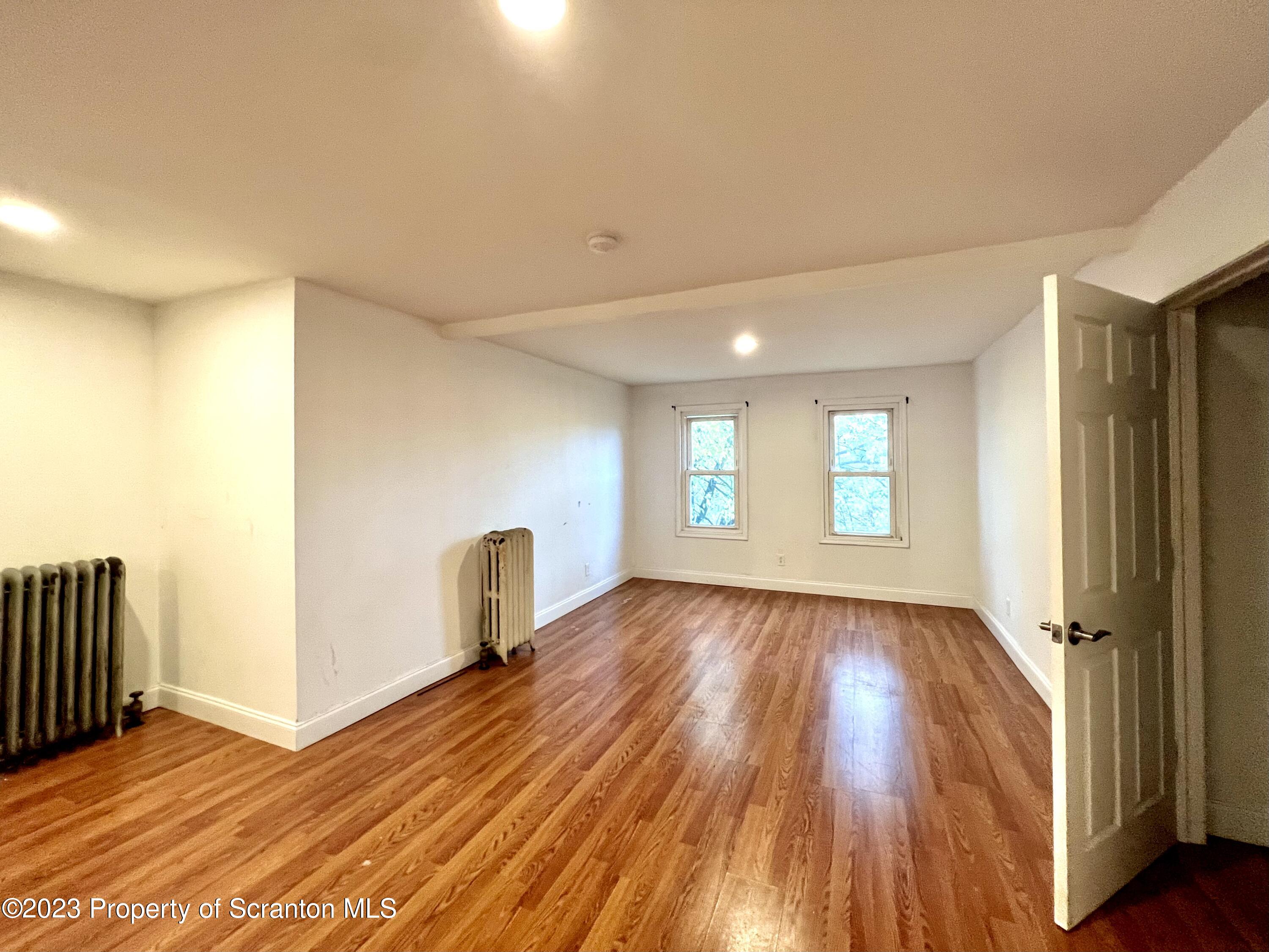 1109 Grove Street Avoca, PA 18641 - Photo 12 of 17 a view of a room with wooden floor and window