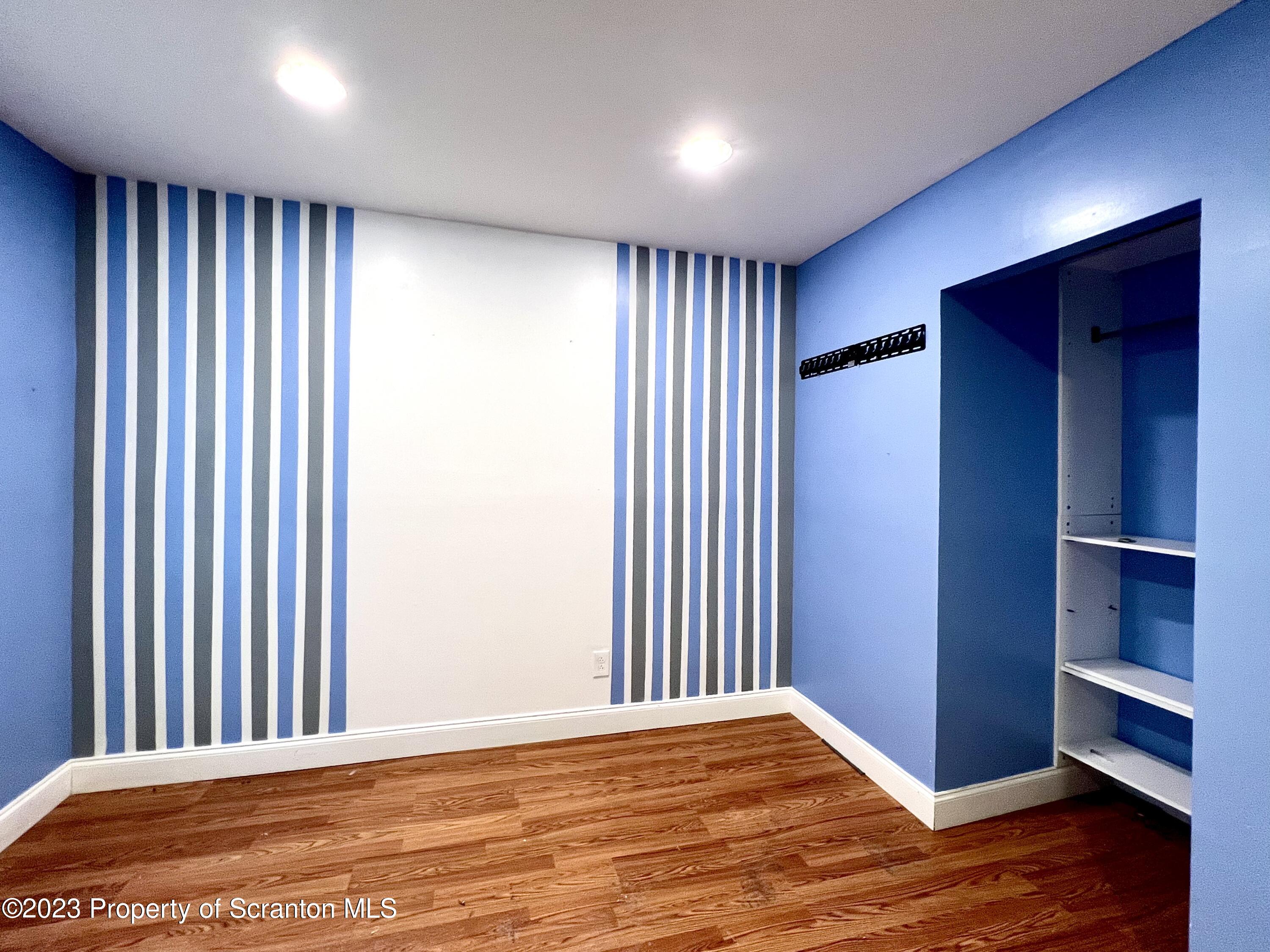 1109 Grove Street Avoca, PA 18641 - Photo 13 of 17 a view of an empty room with wooden floor and a window