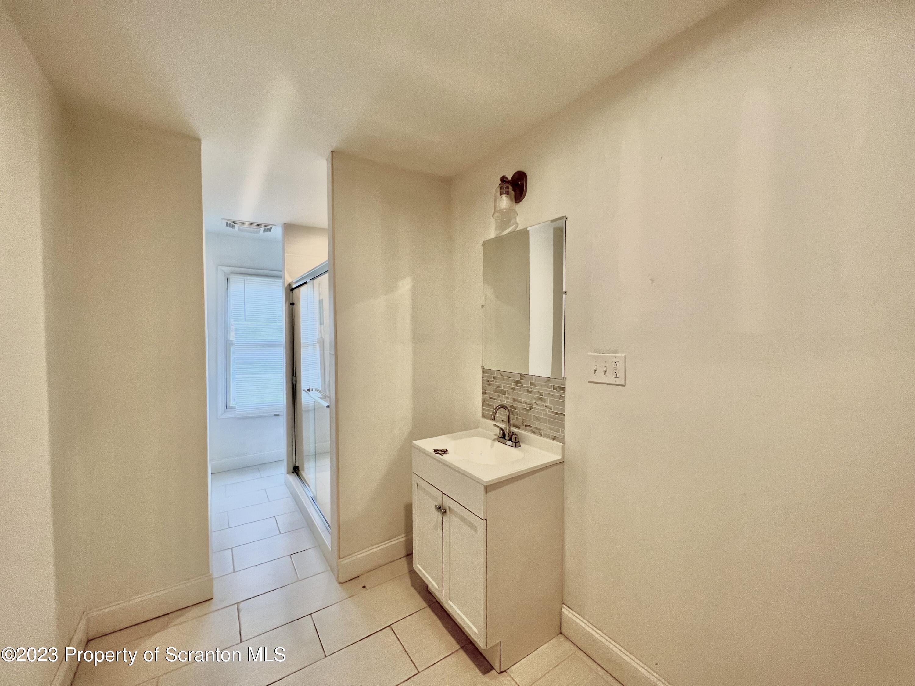 1109 Grove Street Avoca, PA 18641 - Photo 14 of 17 a bathroom with a sink and a mirror