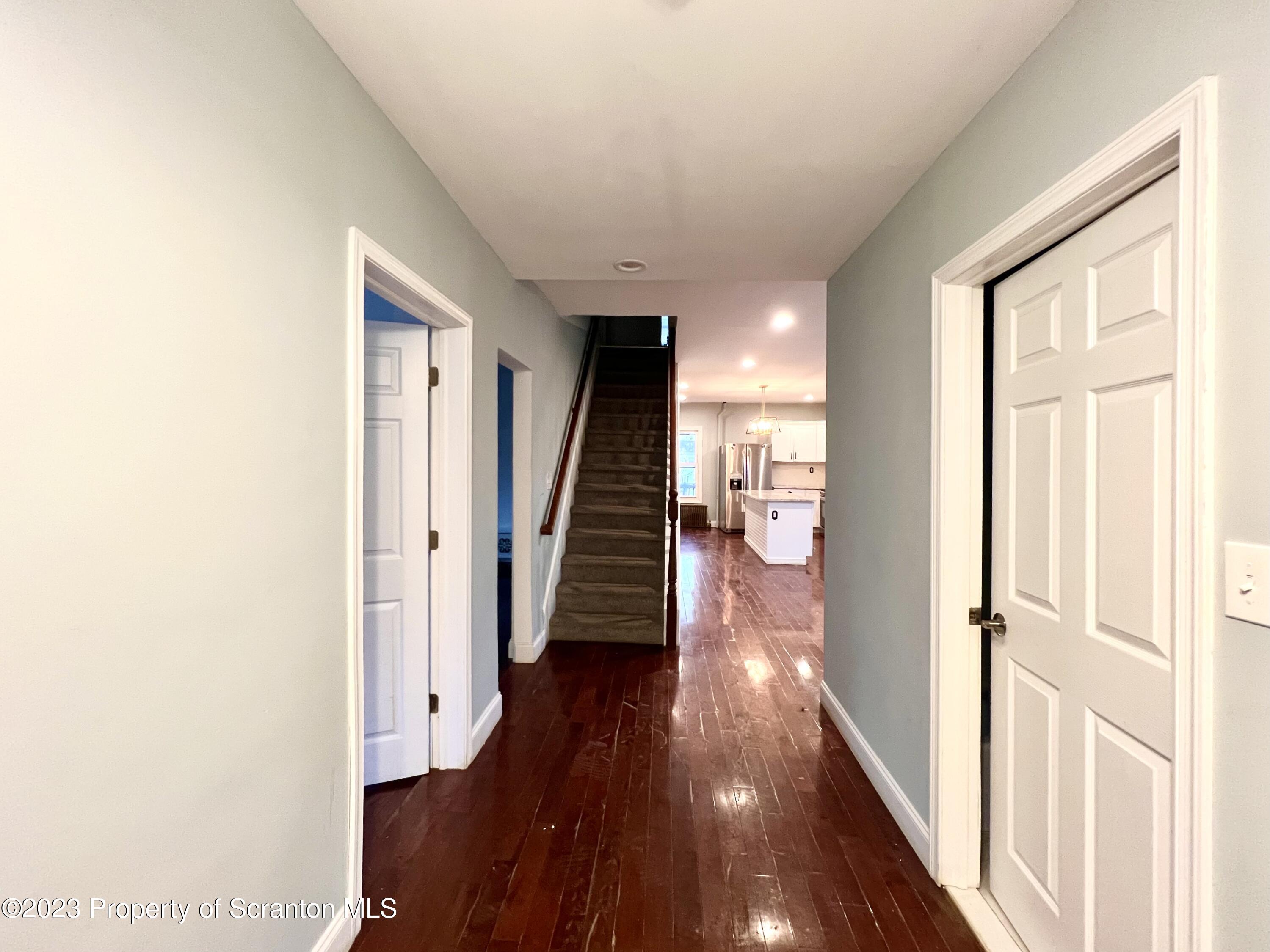 1109 Grove Street Avoca, PA 18641 - Photo 2 of 17 a view of a hallway with wooden floor and staircase