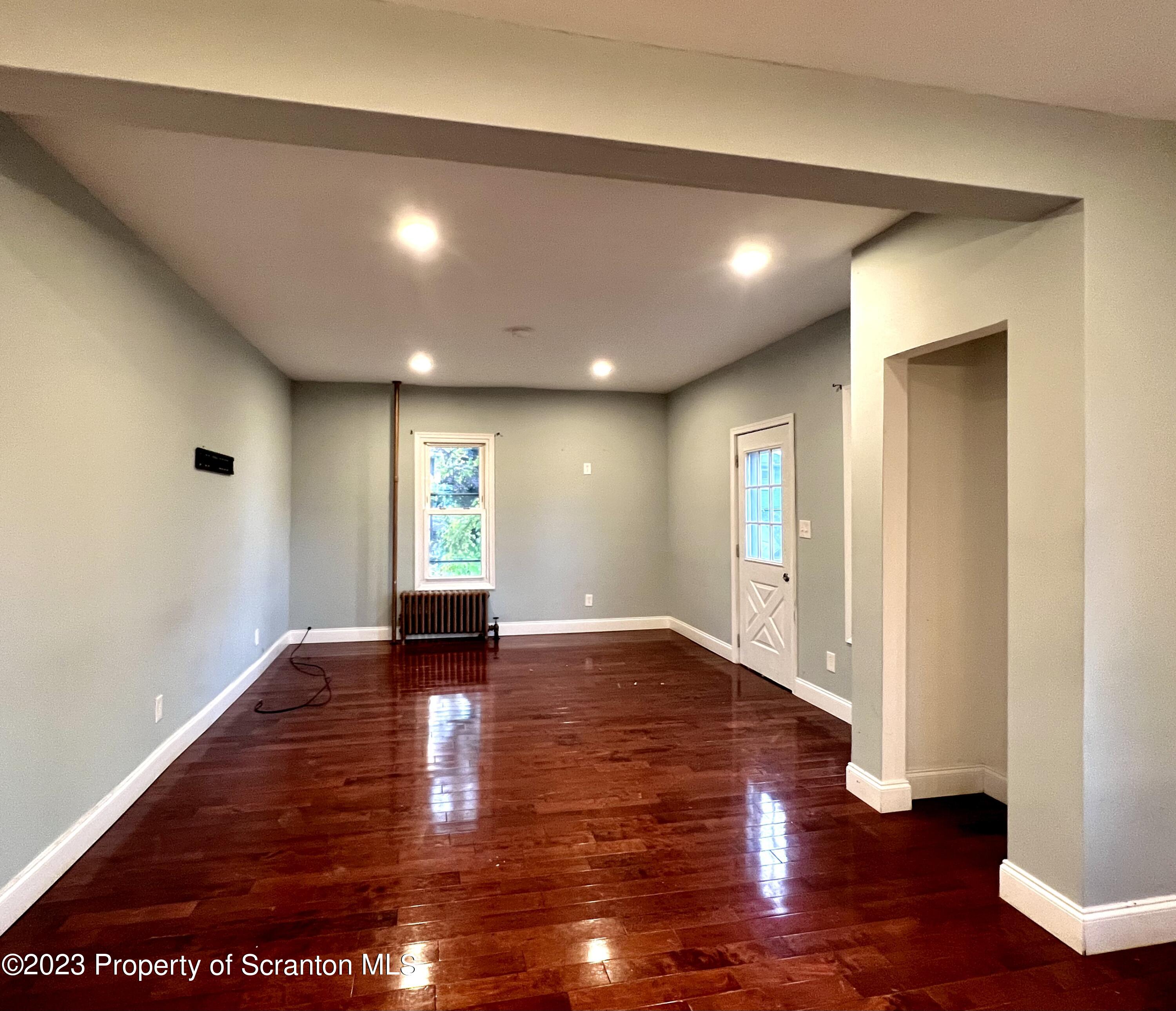 1109 Grove Street Avoca, PA 18641 - Photo 7 of 17 a view of an empty room with wooden floor and window