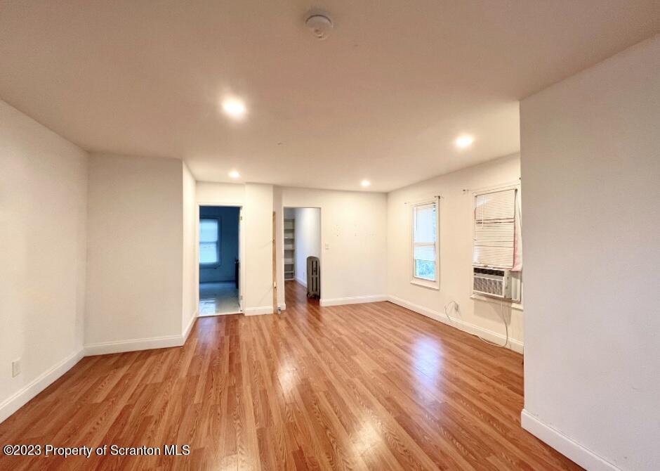 1109 Grove Street Avoca, PA 18641 - Photo 10 of 17 a view of an empty room with wooden floor and a window