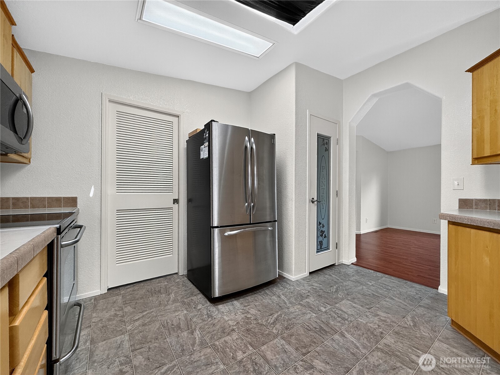 23825 15th Avenue Southeast, Unit 183 Bothell, WA 98021 - Photo 11 of 29 a kitchen with stainless steel appliances granite countertop a refrigerator and a stove