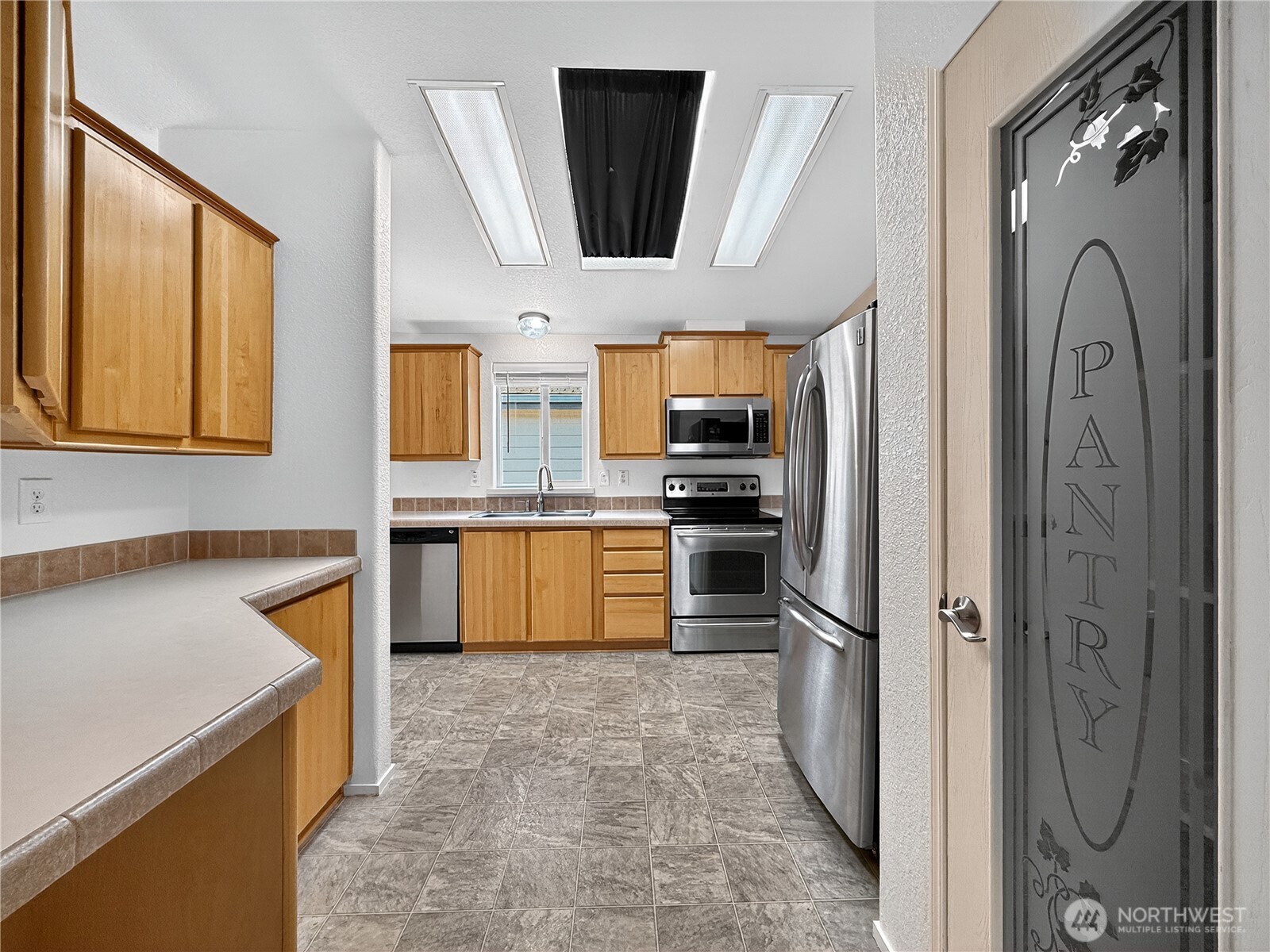 23825 15th Avenue Southeast, Unit 183 Bothell, WA 98021 - Photo 14 of 29 a kitchen with stainless steel appliances granite countertop a refrigerator and a stove top oven