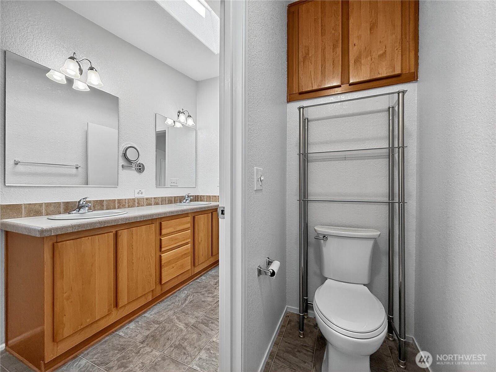 23825 15th Avenue Southeast, Unit 183 Bothell, WA 98021 - Photo 24 of 29 a bathroom with a granite countertop toilet sink and mirror
