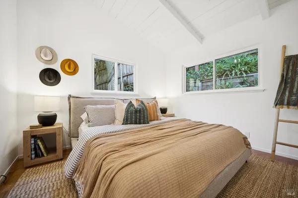 a bedroom with bed and a window