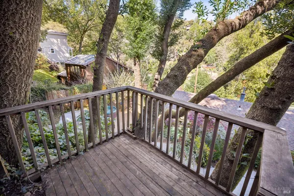 a view of balcony with wooden floor and fence