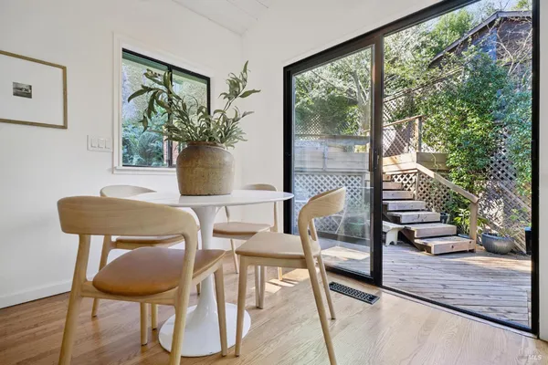 a view of a dining room with furniture window and wooden floor