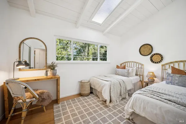 a bedroom with two beds and a window
