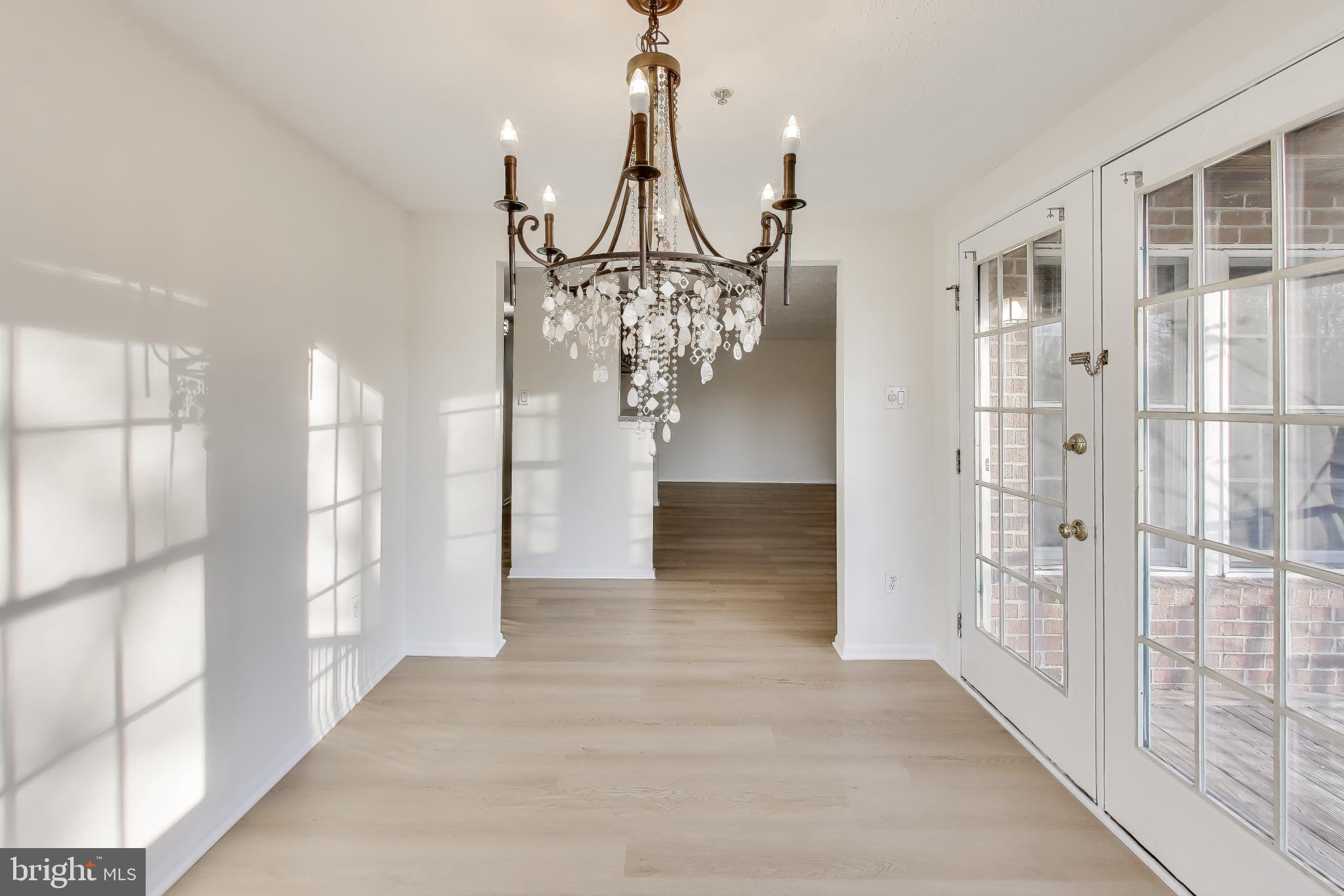 13107 Briarcliff Terrace, Unit 2204 Germantown, MD 20874 - Photo 11 of 30 a view of a hallway with chandelier and glass door