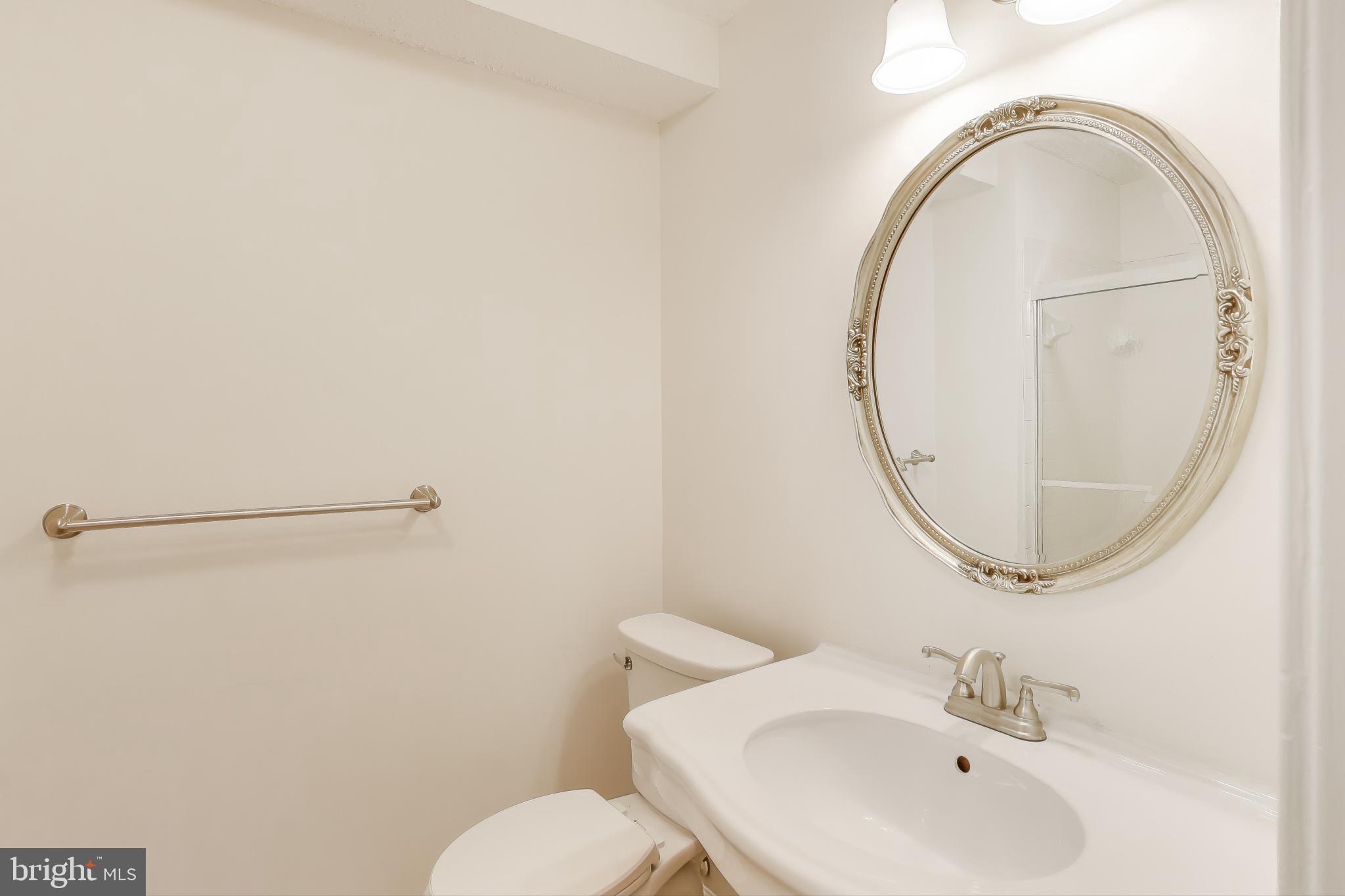 13107 Briarcliff Terrace, Unit 2204 Germantown, MD 20874 - Photo 19 of 30 a bathroom with a sink mirror and toilet