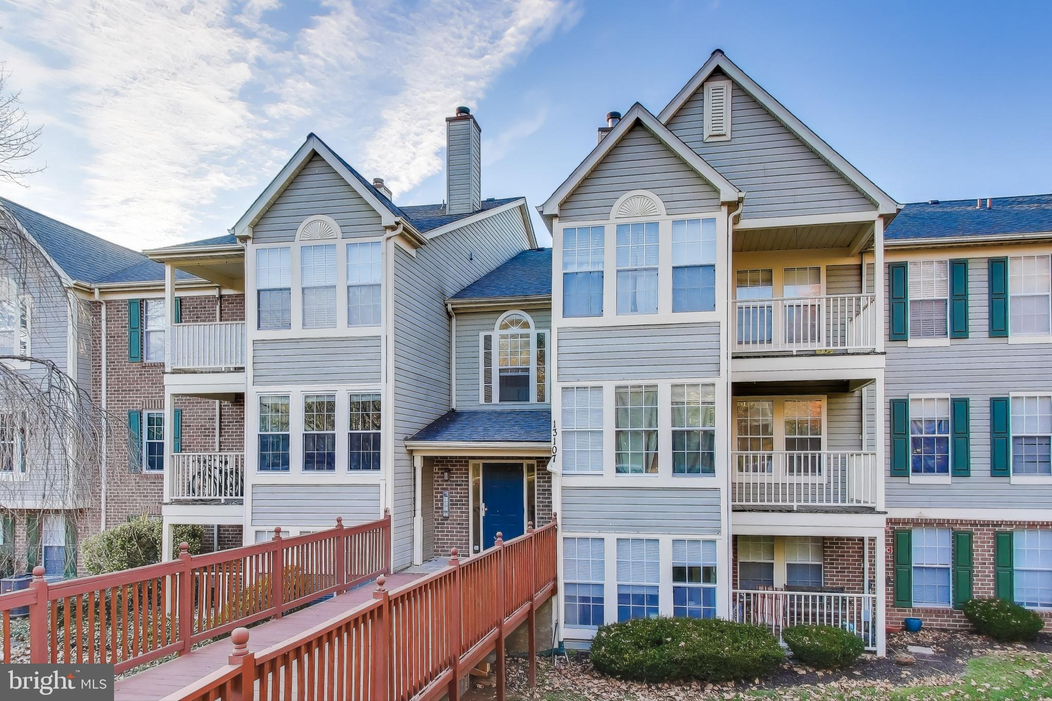 13107 Briarcliff Terrace, Unit 2204 Germantown, MD 20874 - Photo 2 of 30 a view of a big house with large windows and a yard