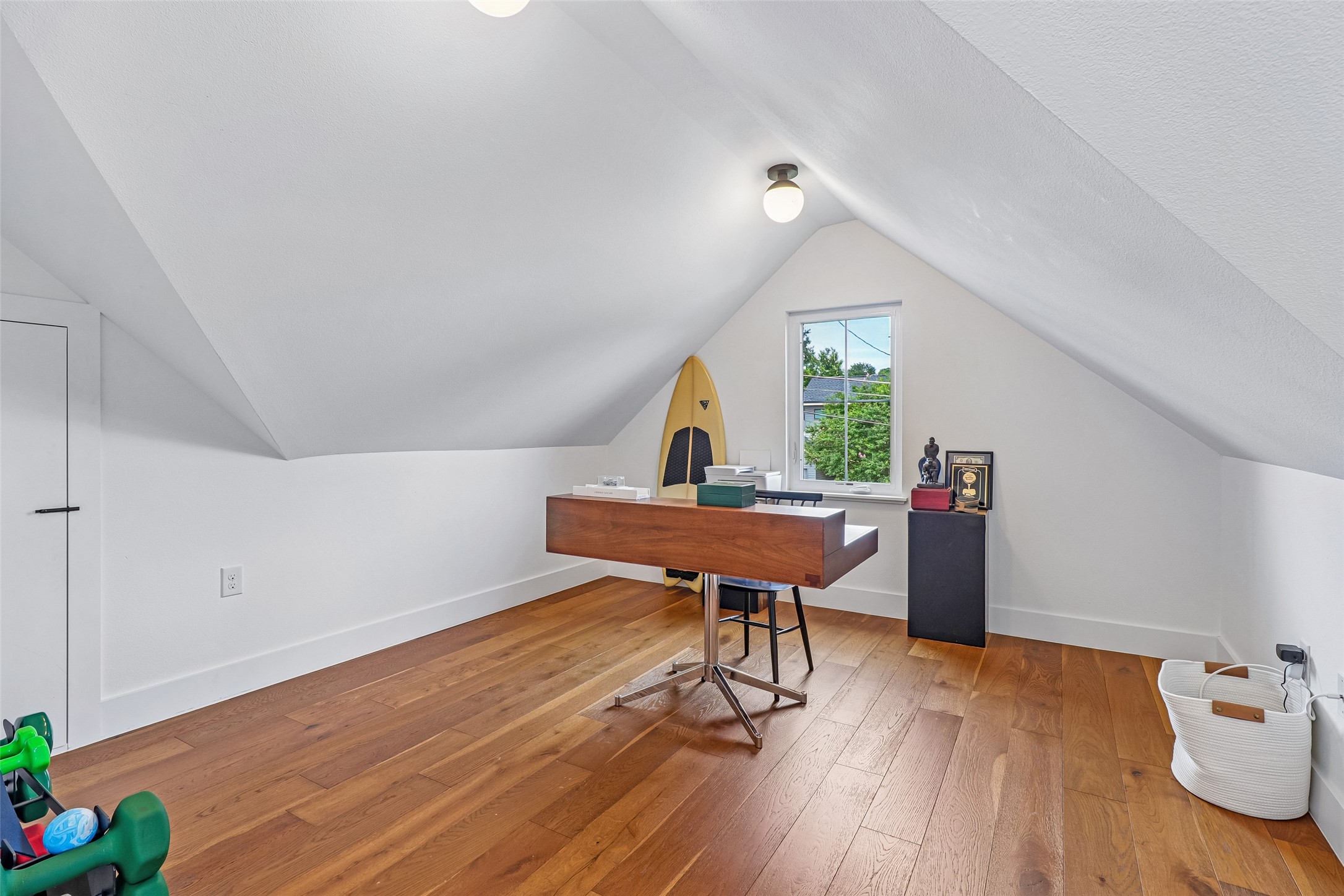 1706 Perez Street, Unit 1 Austin, TX 78721 - Photo 22 of 36 An inviting attic retreat with dormer windows offers rich hardwood floors and abundant natural light.