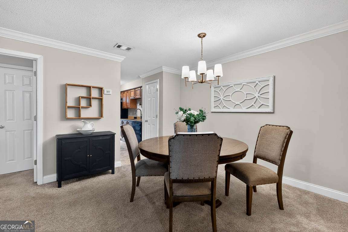 2514 Demere Road, Unit 7 St. Simons, GA 31522 - Photo 7 of 22 a view of a dining room with furniture and wooden floor