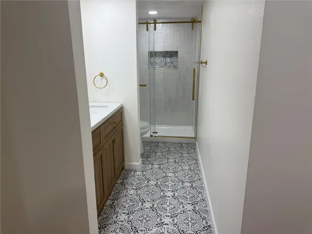 a bathroom with a granite countertop shower and a sink