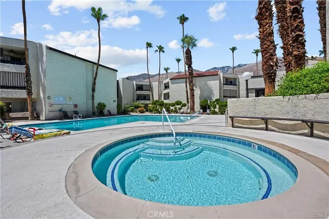 a swimming pool with outdoor seating and yard