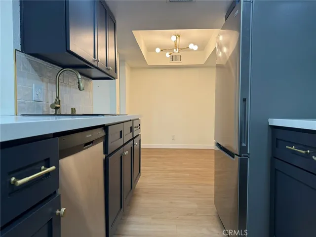 a kitchen with stainless steel appliances a refrigerator and cabinets