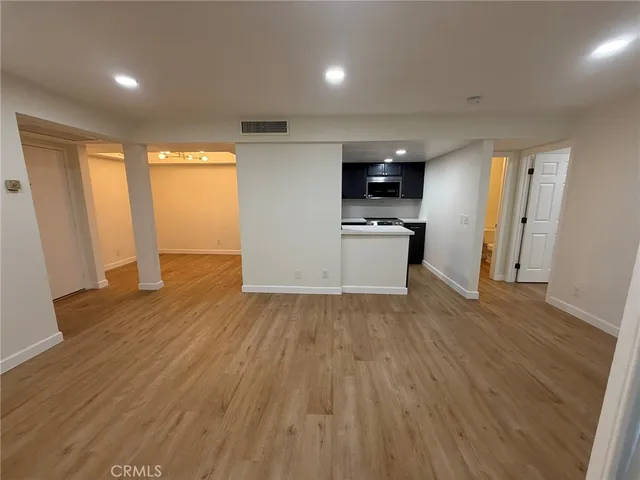 a view of a kitchen with a sink and a refrigerator