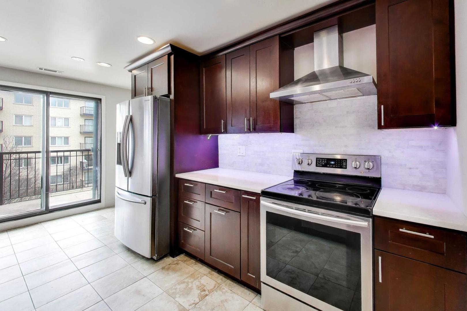 8610 Waukegan Road, Unit 302 Morton Grove, IL 60053 - Photo 11 of 34 a kitchen with a stove and a refrigerator