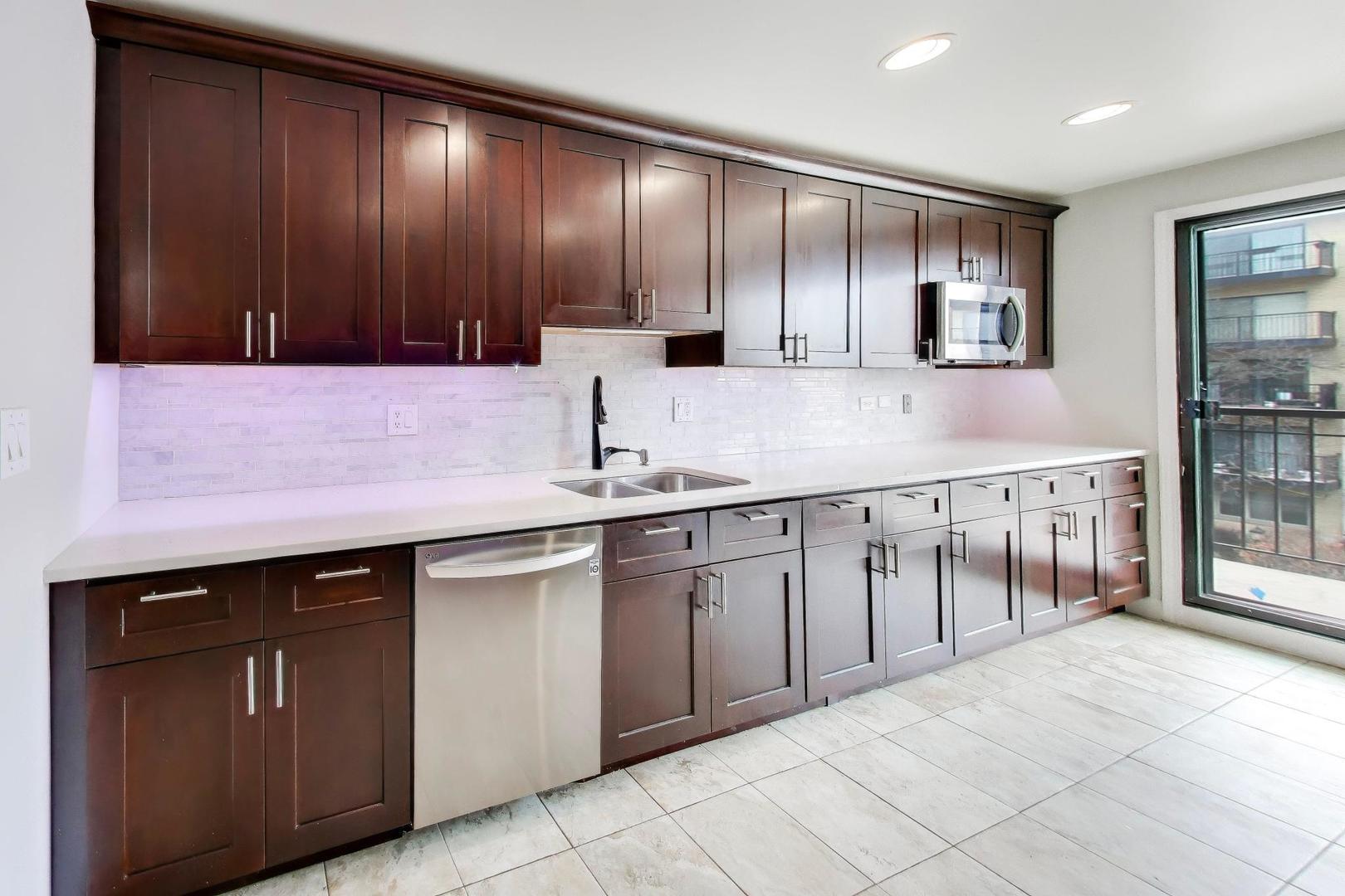 8610 Waukegan Road, Unit 302 Morton Grove, IL 60053 - Photo 13 of 34 a kitchen with stainless steel appliances granite countertop a sink and cabinets