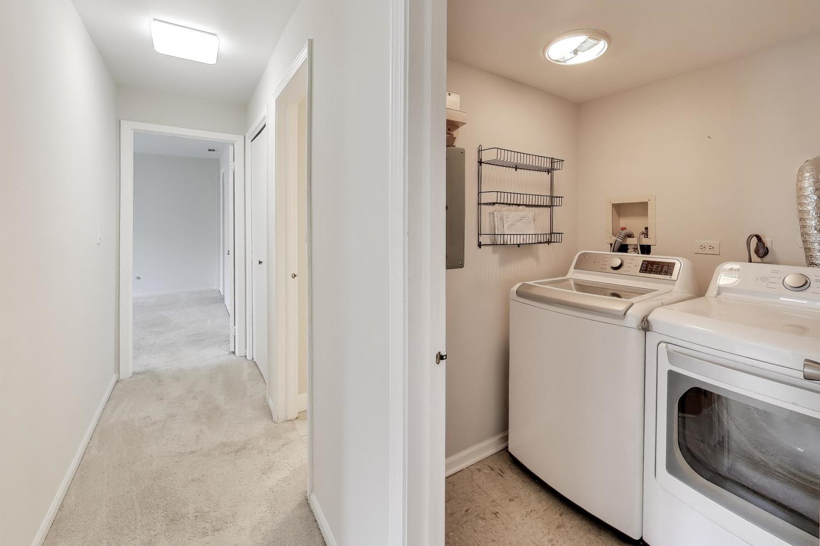 8610 Waukegan Road, Unit 302 Morton Grove, IL 60053 - Photo 16 of 34 a view of storage and utility room with washer and dryer
