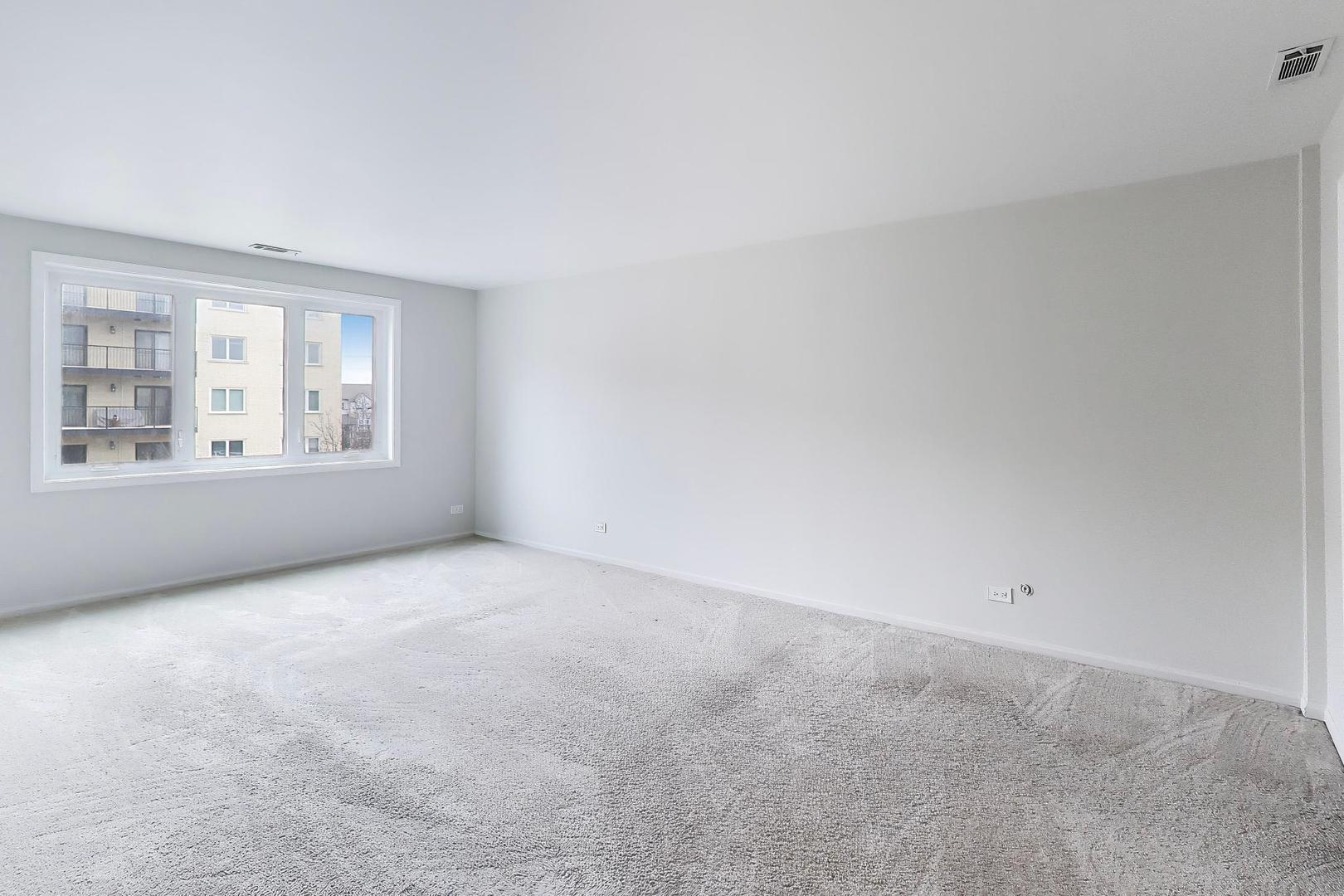 8610 Waukegan Road, Unit 302 Morton Grove, IL 60053 - Photo 17 of 34 a view of an empty room with a window