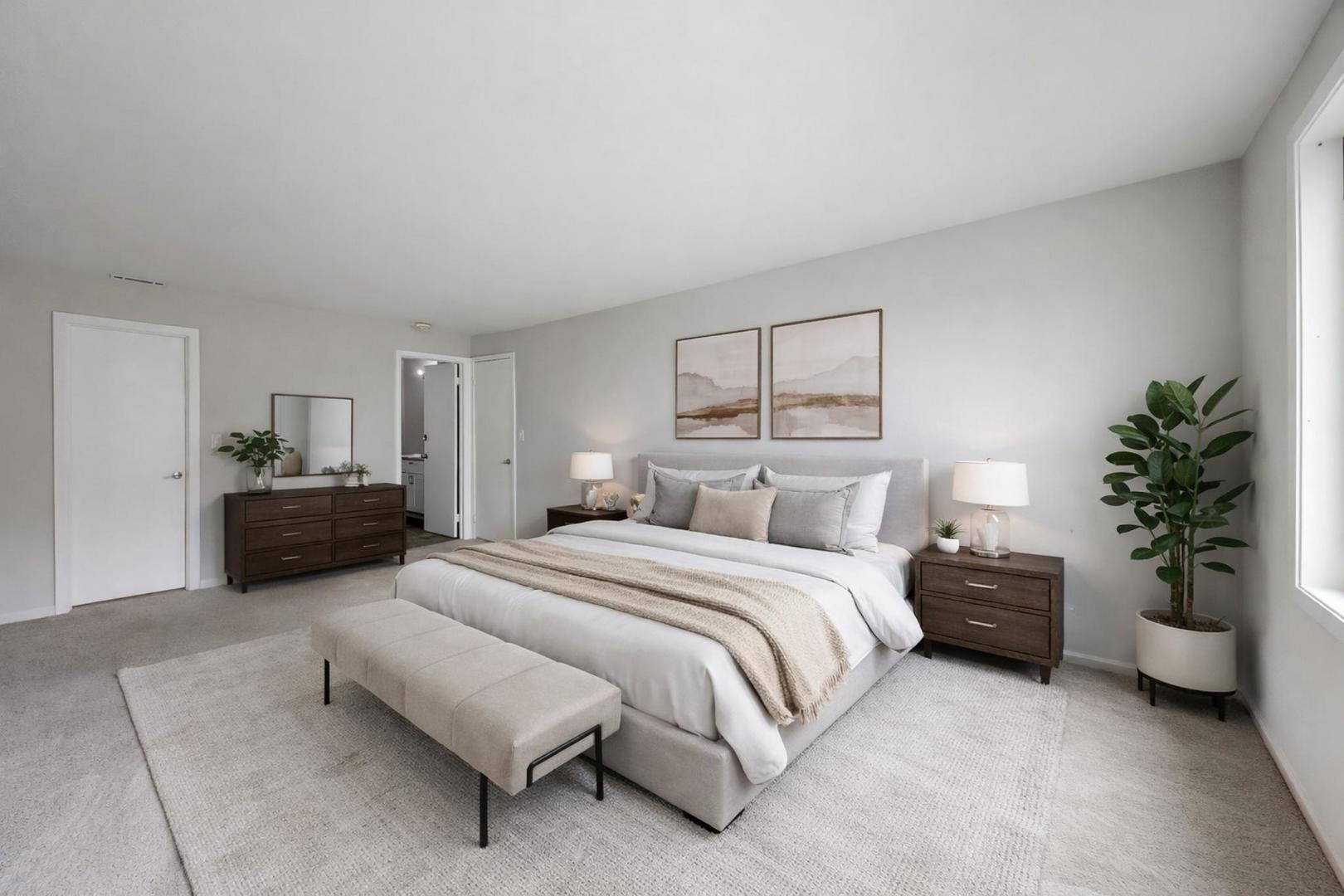 8610 Waukegan Road, Unit 302 Morton Grove, IL 60053 - Photo 19 of 34 a bedroom with a bed and a couch