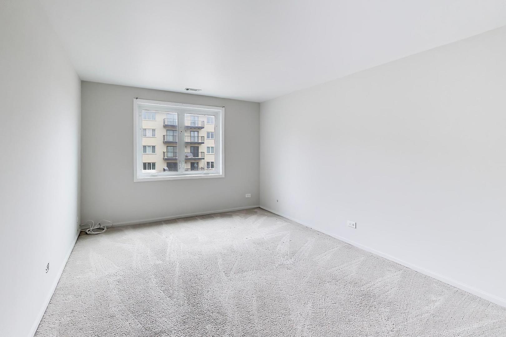 8610 Waukegan Road, Unit 302 Morton Grove, IL 60053 - Photo 25 of 34 an empty room with windows