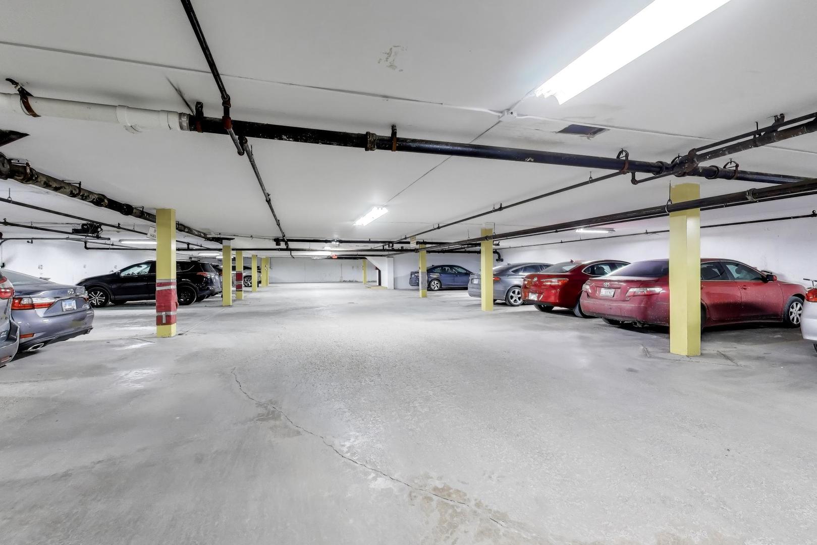 8610 Waukegan Road, Unit 302 Morton Grove, IL 60053 - Photo 31 of 34 a view of parking garage with cars
